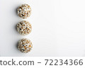 Diet vegetarian energy balls with nuts, dried fruit, chia, oats, cocoa, peanut butter and honey in coconut flakes. White background. 72234366