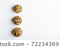 Diet vegetarian energy balls with nuts, chia, sunflower, dried fruit, oats, cocoa, peanut butter and honey. White background. 72234369