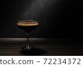 Jelly coffee with milk in a glass bowl sprinkled with chocolate chips. Rustic with deep shadows. 72234372