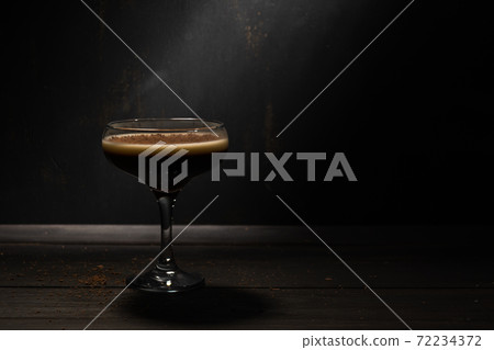 Jelly coffee with milk in a glass bowl sprinkled with chocolate chips. Rustic with deep shadows. Jelly coffee with milk in a glass bowl sprinkled with chocolate chips. Rustic with deep shadows. 72234372