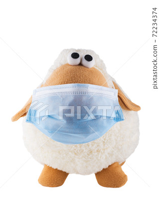 Cute soft toy sheep in a medical mask on a white background. Isolate. Cute soft toy sheep in a medical mask on a white background. Isolate. 72234374