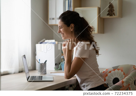 Overjoyed woman using laptop, chatting online, making video call Overjoyed woman using laptop, chatting online, making video call 72234375