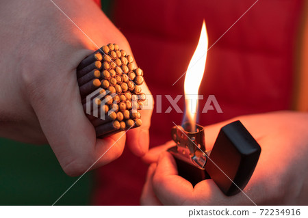 Man in Red Jacket Lighting Up Many Small Firecrackers 72234916