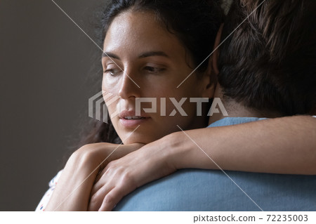 Close up thoughtful woman hugging man, thinking about relationship problems Close up thoughtful woman hugging man, thinking about relationship problems 72235003