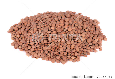 Brown lentils beans isolated on white background. Brown lentils beans isolated on white background. 72235055