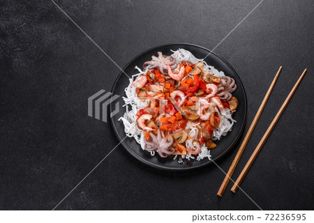 Tasty rice noodles with tomato, red pepper, mushrooms and seafood 72236595