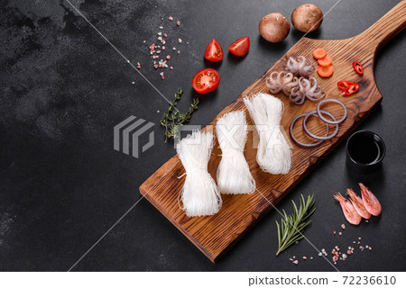 Tasty rice noodles with tomato, red pepper, mushrooms and seafood Tasty rice noodles with tomato, red pepper, mushrooms and seafood 72236610