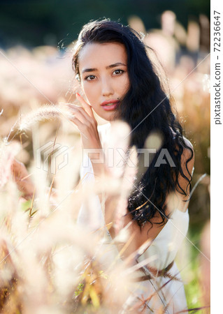 Fashion close-up portrait of young woman posing at grassplot Fashion close-up portrait of young woman posing at grassplot 72236647