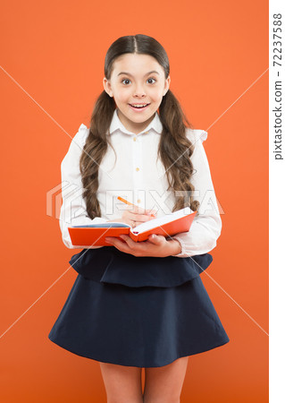 school diary for making notes. surprised small girl in school uniform. school diary for making notes. surprised small girl in school uniform. 72237588