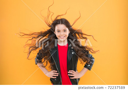 Her hair radiates health.Girl adorable kid long wavy hairstyle. Wind 72237589