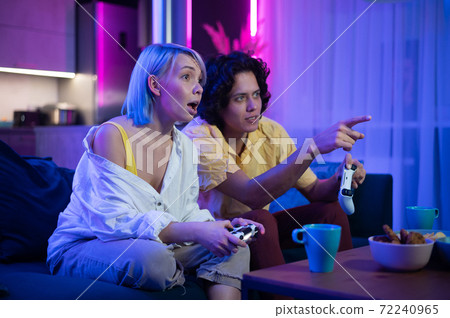 Cheerful boyfriend and girlfriend playing video games to win. Happy couple  using controller to play online game and winning gameplay on console.  People holding joystick to have fun Stock Photo - Alamy