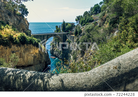 Fiordo di Furore, Amalfi coast, panoramic scenic aerial view to the arched bridge between rocks of fjord, stairs and sea 72244228