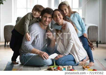 Happy small preschool kids siblings cuddling loving parents. Happy small preschool kids siblings cuddling loving parents. 72245562