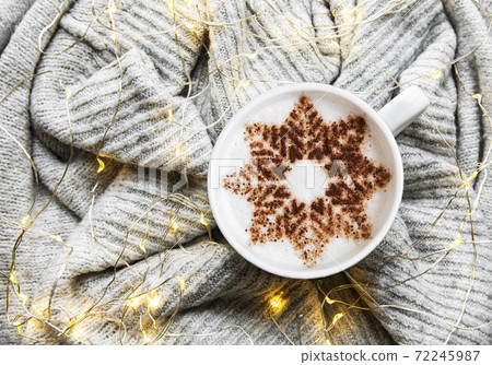 Coffee with a snowflake pattern on a warm knitted sweater Coffee with a snowflake pattern on a warm knitted sweater 72245987