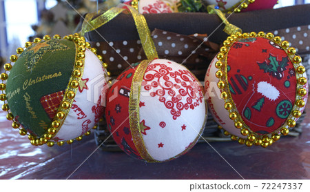 Christmas decorations made of wool, balls, placed on the table before New Year Day Christmas decorations made of wool, balls, placed on the table before New Year Day 72247337