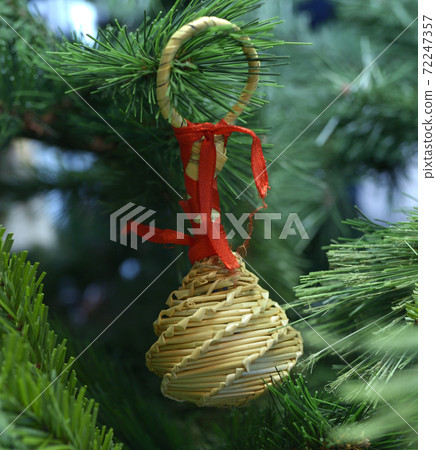 Christmas decoration, handicraft toys made of straw, hanging on a Christmas tree before New Year Day Christmas decoration, handicraft toys made of straw, hanging on a Christmas tree before New Year Day 72247357