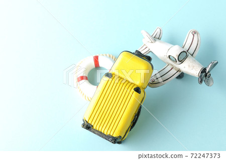 Taking a picture of a trip using a miniature model of an airplane or suitcase 72247373