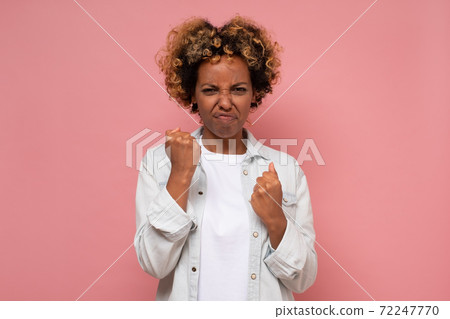 Worried girl clenching fists feeling anxious and nervous, expecting something Worried girl clenching fists feeling anxious and nervous, expecting something 72247770