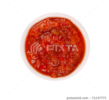 Adjika sauce in bowl, isolated on white background. Spicy tomato and chili pepper sauce. Top view. 72247775