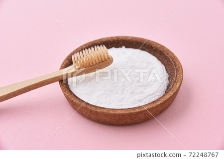 Bamboo toothbrush and baking soda on pink background. Zero waste concept 72248767