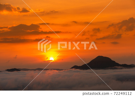 Beautiful dramatic sunset in the mountains. Landscape lot of fog Phu Thok Mountain at Chiang Khan ,Loei Province in Thailand. Beautiful dramatic sunset in the mountains. Landscape lot of fog Phu Thok Mountain at Chiang Khan ,Loei Province in Thailand. 72249112