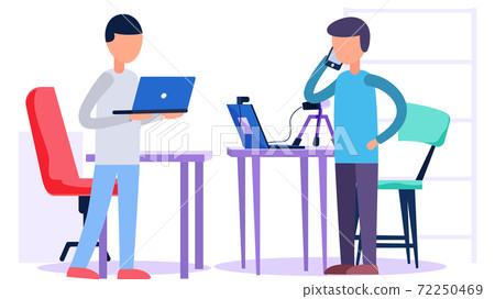 The man is talking on the phone. The guy works on a laptop. People in the recording studio 72250469
