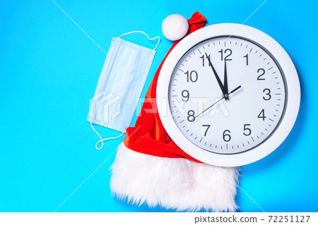 Merry Christmas. flat lay with medical mask. clock. copyspace. the concept of a new year, a coronavirus Merry Christmas. flat lay with medical mask. clock. copyspace. the concept of a new year, a coronavirus 72251127