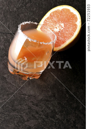 Pink salty dog with salt on the edge of the glass and cut grapefruit Pink salty dog with salt on the edge of the glass and cut grapefruit 72251933
