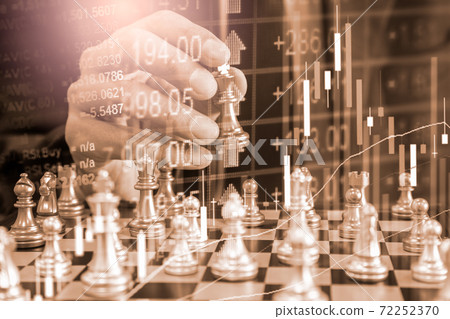 Chess game on chess board behind business man background. Business concept to present financial information and marketing strategy analysis. Investment target in global economy and digital commercial. 72252370