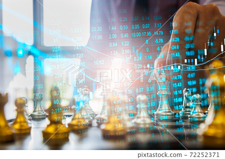 Chess game on chess board behind business man background. Business concept to present financial information and marketing strategy analysis. Investment target in global economy and digital commercial. 72252371