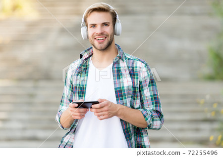 Go wireless with technology. Happy man play music  72255496