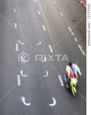 attractive man riding on a motorbike in the road 72255593