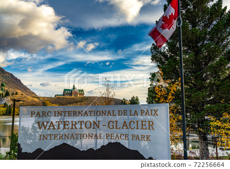 Waterton-Glacier International Peace Park in autumn foliage season. Waterton lake shore at dawn, beautiful fiery clouds in sunrise time. Waterton Lakes National Park, Alberta, Canada. 72256664