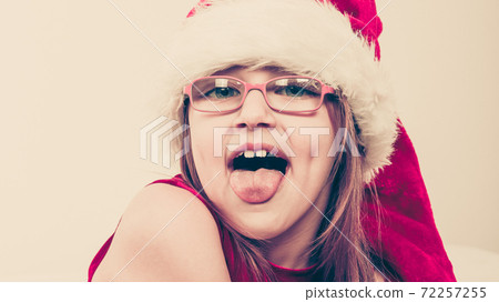 Little girl looking like santa elf. 72257255
