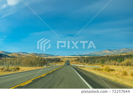 Country road, rural landscape in autumn season. Alberta Provincial Highway No. 22, also known as the Cowboy Trail. Alberta, Canada. Country road, rural landscape in autumn season. Alberta Provincial Highway No. 22, also known as the Cowboy Trail. Alberta, Canada. 72257644