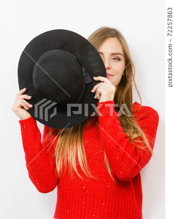 Young lady hiding her face. 72257863