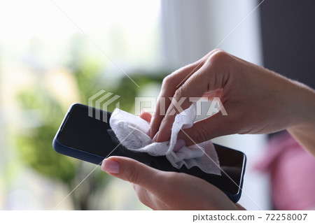 Hand clean space of phone screen with wet wipe from dust. Hand clean space of phone screen with wet wipe from dust. 72258007