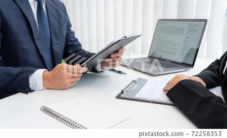 confident businessman sitting in front of office manager talk conducting to interviewer with colleague or boss for business 72258353