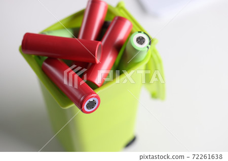 Electronic batteries lying in plastic toy container closeup Electronic batteries lying in plastic toy container closeup 72261638