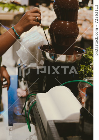 chocolate fondue fountain dripping sauce 72263113