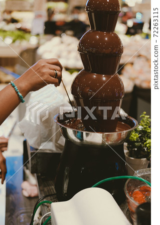 chocolate fondue fountain dripping sauce 72263115