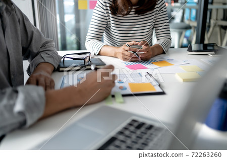 Group of businessmen is discussing in the office about the company profit figures.. Group of businessmen is discussing in the office about the company profit figures.. 72263260
