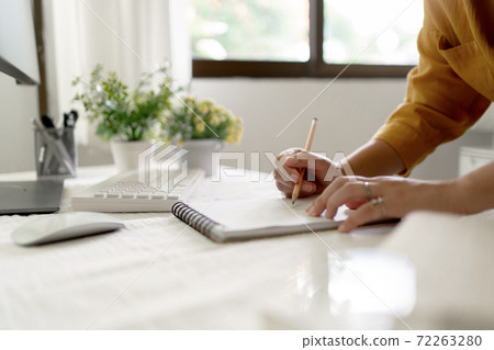 Artist or creative designer drawing on sketch book with new project design.. Artist or creative designer drawing on sketch book with new project design.. 72263280