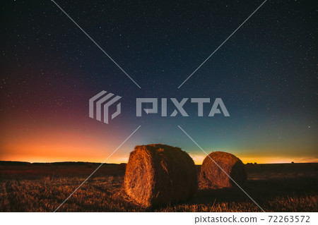Comet Neowise C2020 F3 In Night Starry Sky Above Haystacks In Summer Agricultural Field. Night Stars Above Rural Landscape With Hay Bales After Harvest. Agricultural Concept 72263572