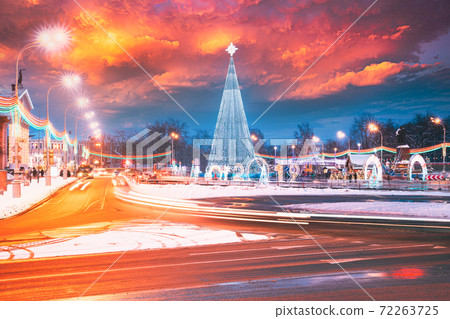 Gomel, Belarus. Main Christmas Tree And Festive Illumination On Lenin Square In Gomel. New Year In Belarus. Altered Sunset Sky Gomel, Belarus. Main Christmas Tree And Festive Illumination On Lenin Square In Gomel. New Year In Belarus. Altered Sunset Sky 72263725
