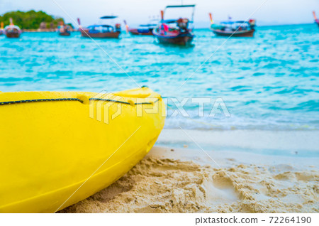Yellow kayak boat on white sand beach 72264190