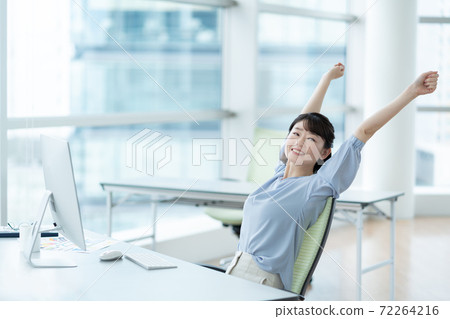 Woman stretching in the office 72264216