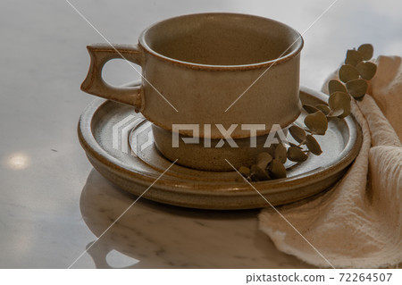 Ceramic mug handmade with Dried flower on marble table . 72264507