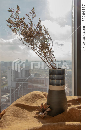 Dried flowers in beautiful ceramic blue vase handmade on table. Dried flowers in beautiful ceramic blue vase handmade on table. 72264557