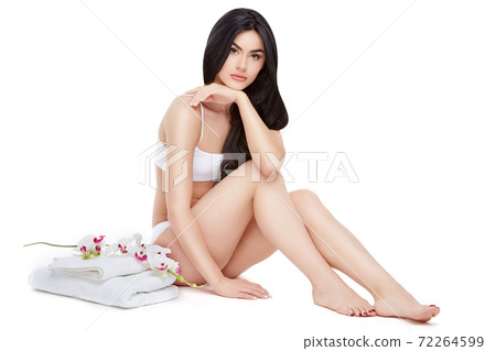 Fitness young woman with a beautiful body sitting on white background 72264599